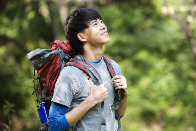 focused_182387448-stock-photo-chinese-male-hiker-looking-woods